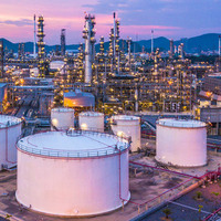 Aerial top view oil and gas chemical tank with oil refinery plant background at twilight.